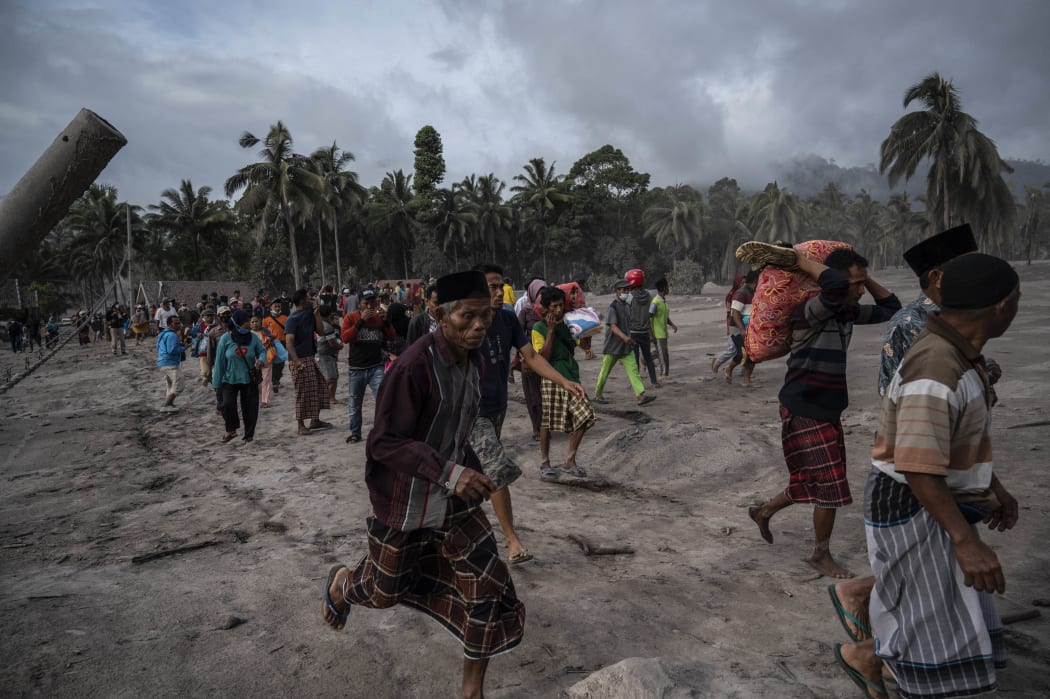Villagers salvage their belongings in an area covered in volcanic ash at Sumber Wuluh village in Lumajang.