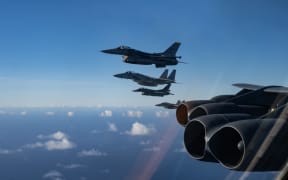 U.S. Navy E/A-18 Growler, Japanese Air Self-Defense Force F-2, JASDF F-15MJ and U.S. Air Force F-16CM fly next to a USAF B-52H Stratofortress over Tinian and Saipan during Cope North 24, Feb. 6, 2024. Cope North gives participants the opportunity to exercise interoperability through agile combat employment and integrated generation of airpower from dispersed locations across the Indo-Pacific. (U.S. Air Force photo by Airman 1st Class Alyssa Bankston)