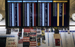 A flight information board shows cancelled flights at Hong Kong's international airport