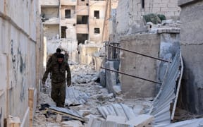 Syrian pro-government forces inspect an area in the Masaken Hanano district in eastern Aleppo, a day after they resized it from rebel fighters.