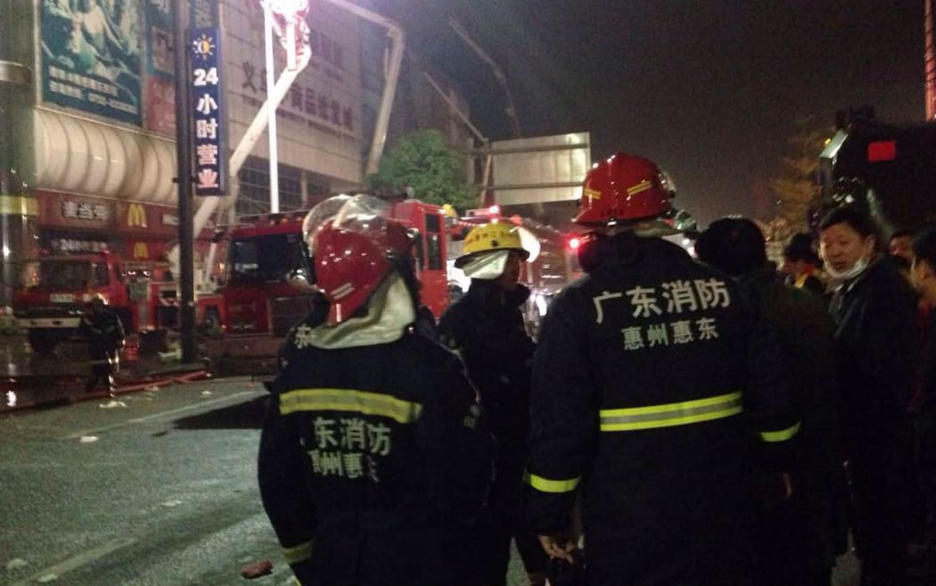 Chinese firefighters at the site after a fire killed over 17 people in a warehouse in South China's Guangdong province.