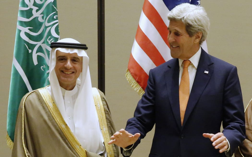 Saudi Arabia's Foreign Minister Adel al-Jubeir poses with US Secretary of State John Kerry in Bahrain.