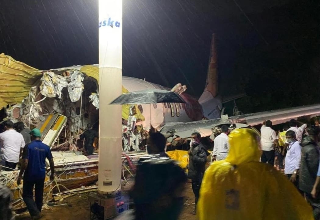 KERALA, INDIA - AUGUST 07: Teams conduct search and rescue operation at the site after an Air India Express passenger plane with 191 passengers onboard skidded off the runway in the southern Indian state of Kerala on August 07, 2020.