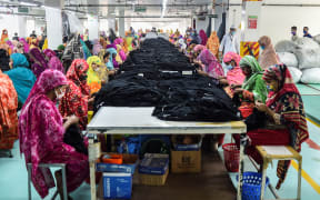 In this picture taken on March 15, 2021, women work in a garment factory in Gazipur in Bangladesh.
