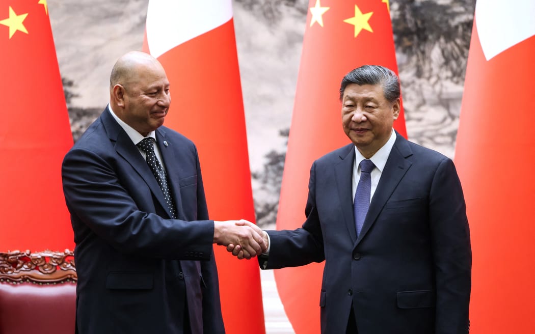 Tonga's King Tupou VI and China’s President Xi Jinping shake hands after a signing ceremony at the Great Hall of the People in Beijing on November 25, 2025. (Photo by Maxim Shemetov / POOL / AFP)
