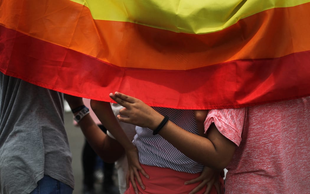 Rainbow flag during a women's day rally in Jakarta, on March 4, 2017, as part of March 8 International women's day celebrations. Everyone of all gender, culture, religion and race is welcome to join this exciting march that aims to unite and celebrate women throughout Indonesia through music, poetry, culture, and the arts.  (Photo by Afriadi Hikmal/NurPhoto) (Photo by Afriadi Hikmal / NurPhoto / NurPhoto via AFP)