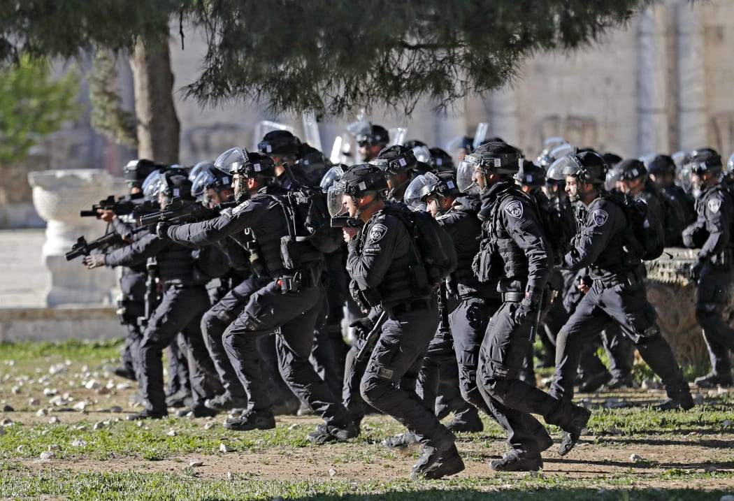 Israeli security forces advance during clashes at Jerusalem's Al-Aqsa mosque compound, on April 15, 2022.