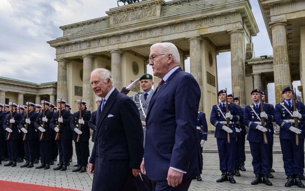 Britain's King Charles III and German President Frank-Walter Steinmeier inspect a guard of honour during a ceremonial welcome at Brandenburg Gate in Berlin, on March 29, 2023. - Britain's King Charles III began his first state visit, having postponed a trip to France due to widespread political protests. Charles will undertake engagements in the German capital and in Brandenburg before heading to Hamburg during the three-day tour. (Photo by John MACDOUGALL / AFP)