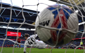 Manchester United's Danish striker Rasmus Hojlund scores the winning penalty in the shoot-out during the English FA Cup semi-final football match against Coventry City at Wembley Stadium, 2024.