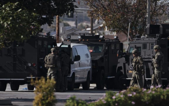 TORRANCE, CA - JANUARY 22: Law enforcement surrounds a white van in a parking lot that is being investigated for a possible connection to the earlier Monterey Park mass shooting on January 22, 2023 in Torrance, California. 10 people were killed and 10 more injured at a dance studio in Monterey Park near a Lunar New Year celebration on Saturday night.   Eric Thayer/Getty Images/AFP (Photo by Eric Thayer / GETTY IMAGES NORTH AMERICA / Getty Images via AFP)
