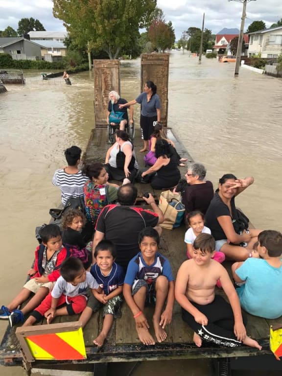 Edgecumbe residents evacuate the town on board a flatdeck truck