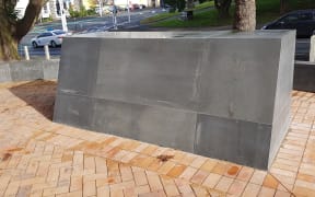 The judge's name has been removed from the large marble plinth.