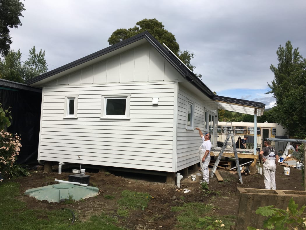 The exterior of the house as painters put finishing touches on.