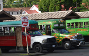 The colorful local “aiga buses” at the depot in Fagatogo