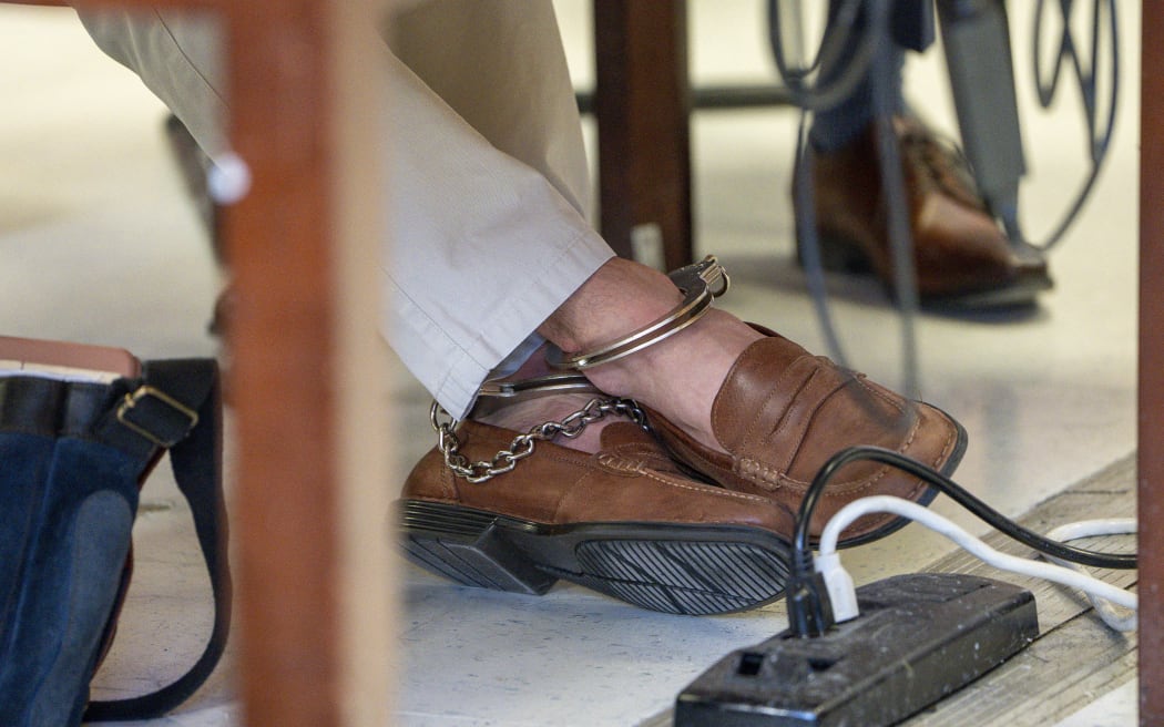 The shackled feet of Luigi Mangione, accused killer of US insurance CEO Brian Thompson, are seen as he attends a hearing at the Manhattan Supreme Court in New York City on February 21, 2025. Mangione is accused of gunning down Thompson in a brazen hit in New York on December 4, 2024, pleaded not guilty to state charges including "terrorist" murder. The suspect is charged in both state and federal court. (Photo by Steven HIRSCH / POOL / AFP)