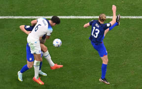 England's defender #06 Harry Maguire (C) fights for the ball with USA's forward #24 Josh Sargent and USA's defender #13 Tim Ream during the Qatar 2022 World Cup Group B football match between England and USA at the Al-Bayt Stadium in Al Khor, north of Doha on November 25, 2022. (Photo by Kirill KUDRYAVTSEV / AFP)