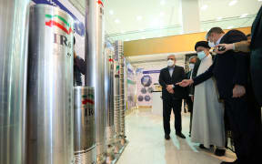 President Ebrahim Raisi (second from right) accompanied by the Atomic Energy Organization of Iran (AEOI) chief Mohammad Eslami (right) at an event during the "Nuclear Technology Day" in the capital Tehran.