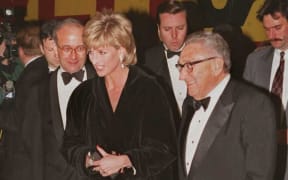 Princess Diana (L) is met by former US Secretary of State Henry Kissinger as she arrives at a black-tie benefit gala in New York 11 December.  At the gala Kissinger will present the Princess with the 1995 United Cerebral Palsy Humanitarian of the Year award for her charity work.   AFP PHOTO   Bob STRONG (Photo by BOB STRONG / AFP)