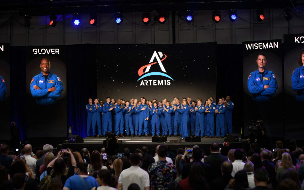 Current NASA astronauts stand on stage before a news conference held by NASA and CSA to announce the four astronauts who will venture around the Moon, at Ellington airport in Houston, Texas, on April 3, 2023. - Traveling aboard NASA’s Orion spacecraft during Artemis II, the mission is the first crewed flight test on the agency’s path to establishing a long-term scientific and human presence on the lunar surface. (Photo by Mark Felix / AFP)