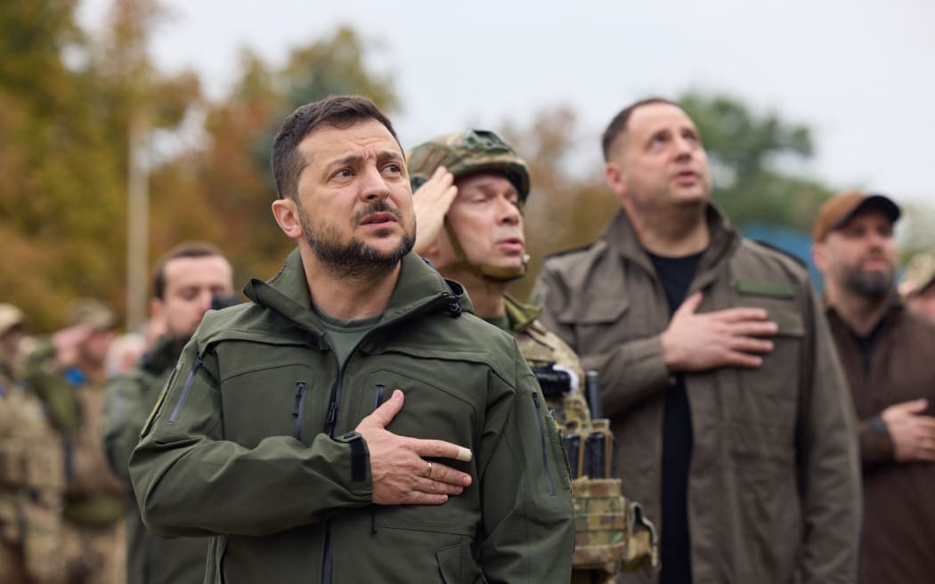 Ukrainian President Volodymyr Zelensky taking part in the state's flag raising in the de-occupied city of Izium, Kharkiv region. Zelensky visited the east Ukraine city - one of the largest recently recaptured from Russia by Kyiv's army in a lightning counter-offensive - on 14 September, 2022, the military said.