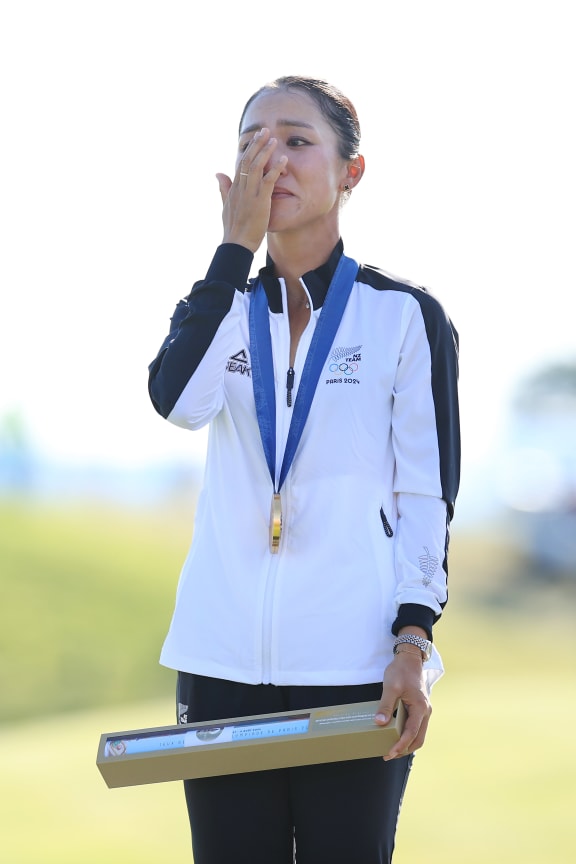 Lydia Ko (NZL) shows her emotion as she stands on the podium with her Gold medal after winning the Women's Individual Stroke Play Golf at Paris 2024.