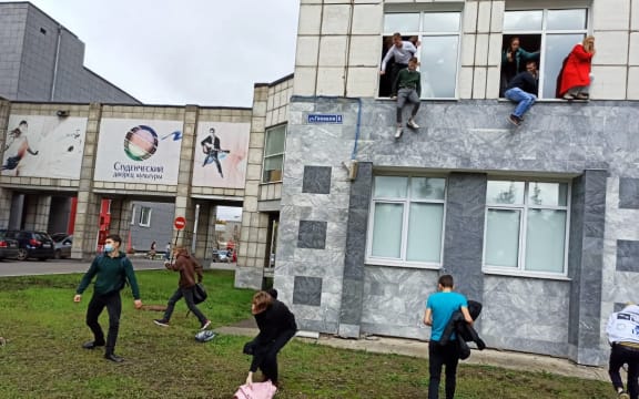 Students jump from windows of Perm State National Research University during a shooting, in Perm, Russia.
