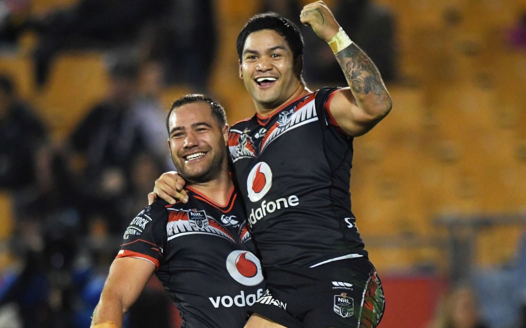 Bodene Thompson celebrates his try with Issac Luke (L).