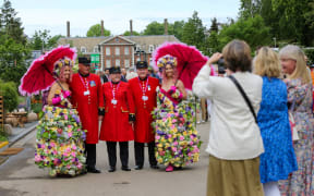 LONDON, UNITED KINGDOM - MAY 23: Women take photos of models wearing floral outfits on the press preview day of the RHS Chelsea Flower Show held by the Royal Horticultural Society at Royal Hospital Chelsea in London, United Kingdom on May 23, 2022. This year's show feature special displays to mark the Queen's platinum jubilee. Dinendra Haria / Anadolu Agency (Photo by Dinendra Haria / ANADOLU AGENCY / Anadolu Agency via AFP)