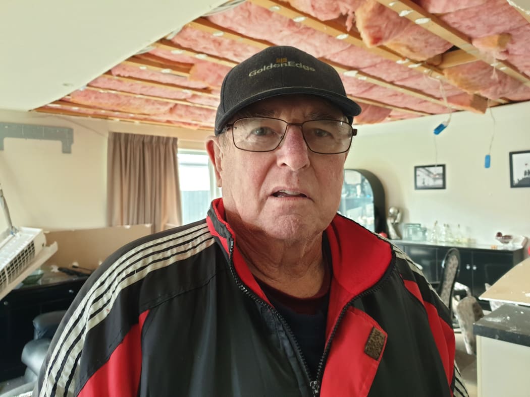 Barry Hobson at his damaged home.