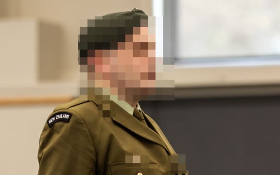 A New Zealand soldier stands at a makeshift courtroom at the Linton Military Camp located near the city of Palmerston North in New Zealand on August 18, 2025. A military court found a New Zealand soldier guilty of attempted espionage for a foreign power on August 18 -- the first spying conviction in the country's history. The man's name, the country he attempted to spy for and the name of the undercover officer who snared him were all suppressed by the court. The soldier was the first person to be convicted of spying by a New Zealand court and only the second to be tried after a former public servant was acquitted of espionage in 1975. (Photo by Adele Rycroft / POOL / AFP)