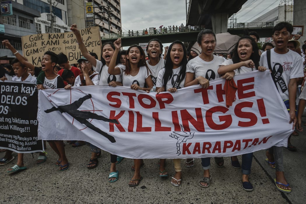 Residents and activists chant slogans during the funeral procession of Kian Loyd Delos Santos in Caloocan, Metro Manila, Philippines, August 26, 2017.