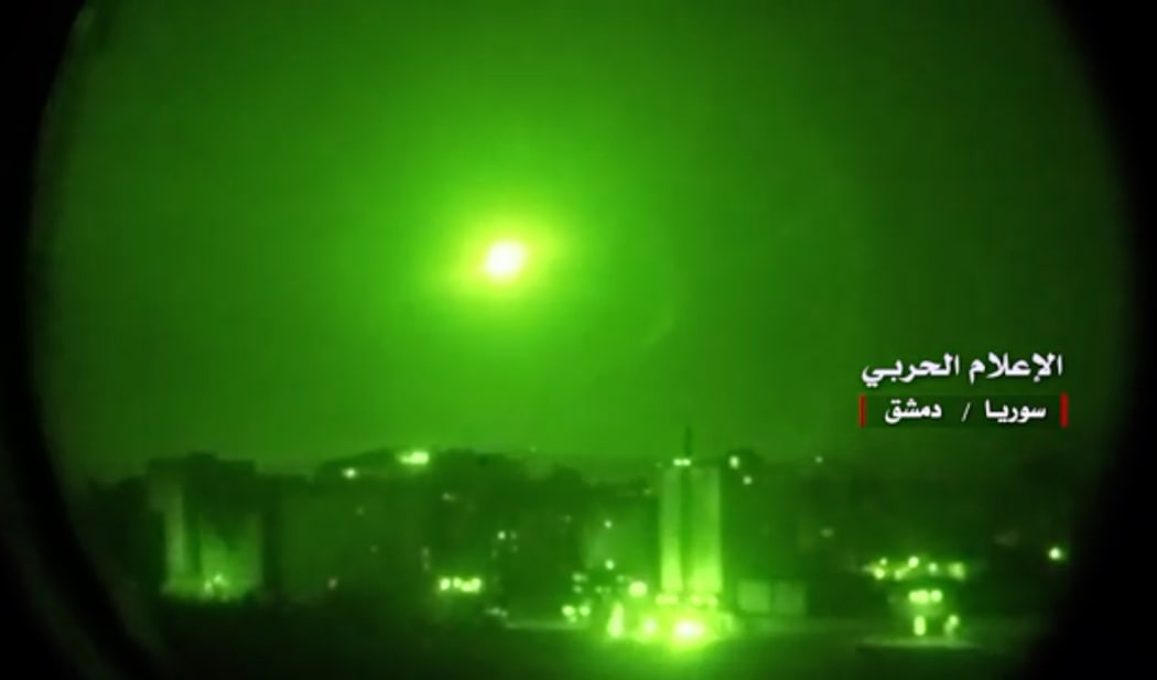 An image grab from a video broadcast on Syria's official TV purportedly shows Syrian air defence systems intercepting Israeli missiles over Syrian airspace.