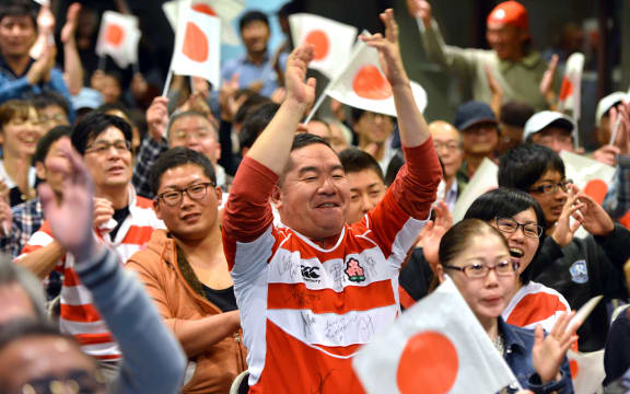 Japanese rugby fans celebrate their team's try during a public viewing of the Rugby World Cup match against the United States in Kumagaya in 2015.