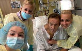 This handout picture posted on September 15, 2020 on the Instagram account of @navalny shows Russian opposition leader Alexei Navalny posing for a selfie picture with his family at Berlin's Charite hospital.