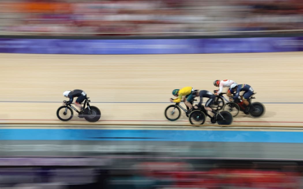 Britain's Jack Carlin cycles ahead of Australia's Matthew Glaetzer, Japan's Shinji Nakano, Colombia's Cristian David Ortega Fontalvo, New Zealand's Sam Dakin and Poland's Mateusz Rudyk in a men's track cycling keirin semi-final of the Paris 2024 Olympic Games at the Saint-Quentin-en-Yvelines National Velodrome in Montigny-le-Bretonneux, south-west of Paris, on August 11, 2024. (Photo by Thomas SAMSON / AFP)