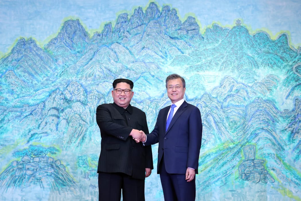 South Korea's President Moon Jae-in (R) shakes hands with North Korea's leader Kim Jong Un (L) during the Inter-Korean summit in the Peace House building on the southern side of the truce village of Panmunjom on April 27, 2018.