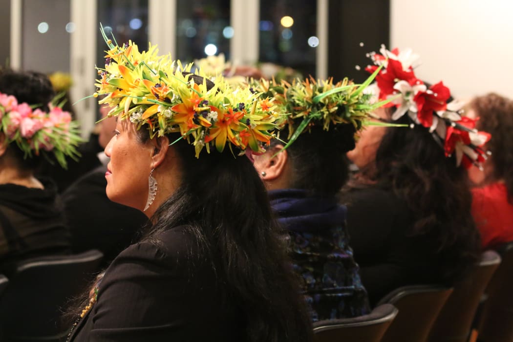 Women wearing head ei at a Cook Islands Constitution day reception in Wellington.