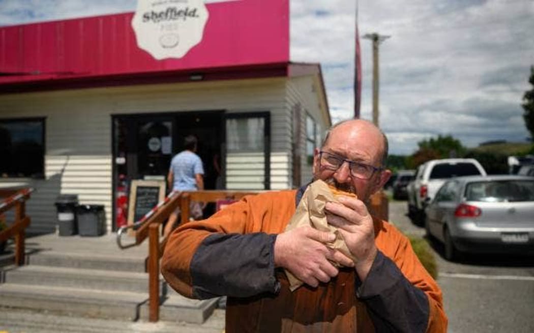 Regular customer Richard Broughton, of Hororata, enjoys a pie in front of the original Sheffield Pies shop.