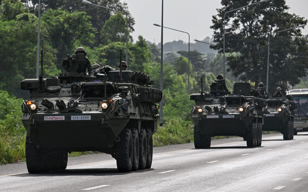 Royal Thai Army soldiers are pictured on armoured vehicles on a road in Chachoengsao province on 24 July, 2025.