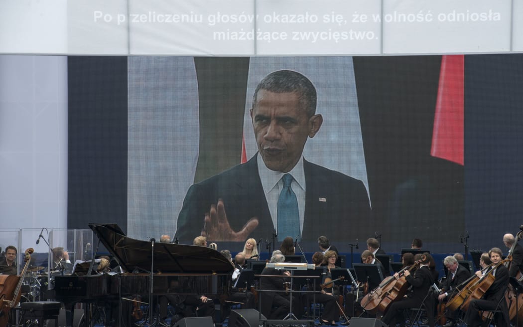 Barack Obama hailed Polish democracy as a beacon for neighbouring Ukraine.