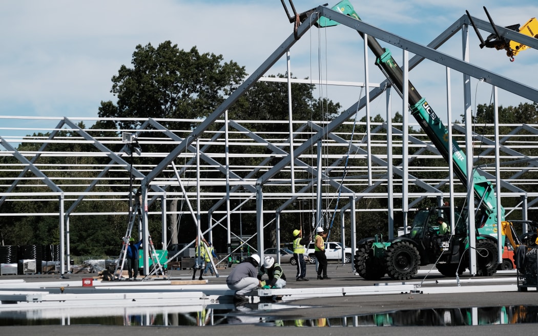 Large tents are constructed in a parking lot at Orchard Beach in the Bronx in New York City, on 27 September. They will be used to house some of the thousands of migrants who have been bussed into the city from southern states since August.