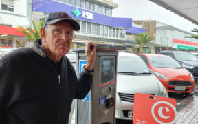 Mike Hignett's coins came tumbling out of the parking meter as fast as he put them in. He doesn't want to pay using his credit card or the PayMyPark app.