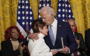 WASHINGTON, DC - JANUARY 6: US President Joe Biden embraces Gladys Sicknick, the mother of late Capitol Police Officer Brian Sicknick, as she accepts a Presidential Citizens Medal on behalf of her late son during a ceremony to mark the two-year anniversary of the January 6th 2021 attack on the U.S. Capitol in the East Room of the White House January 6, 2023. Biden awarded 12 Presidential Citizens Medals to police officers who defended the Capitol and state officials who resisted pressure to overturn the 2020 presidential election results.   Drew Angerer/Getty Images/AFP (Photo by Drew Angerer / GETTY IMAGES NORTH AMERICA / Getty Images via AFP)