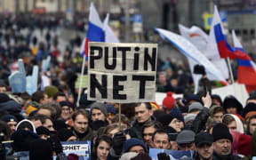 A protester holds a placard reading "Putin - No!" during an opposition rally in central Moscow, on March 10, 2019, to demand internet freedom in Russia.