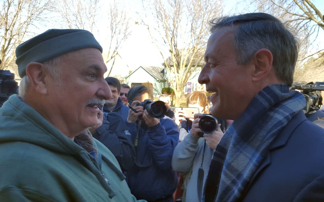 Two men shake hands on a crsip wintery  day
