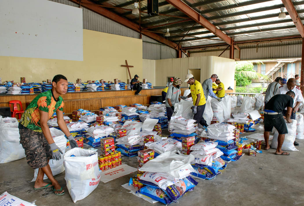 ExxonMobil PNG volunteers packing food supplies to be sent to Moro