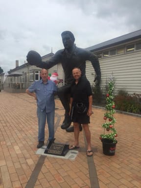 James and Bruce pose with the statue of Colin Meads in Te Kuiti.