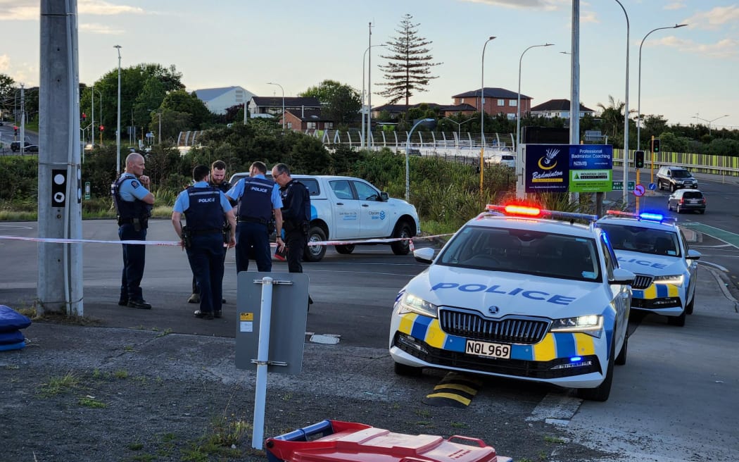 Police at a walkway beside a Massey, West Auckland, badminton centre after what they are calling a sudden death.