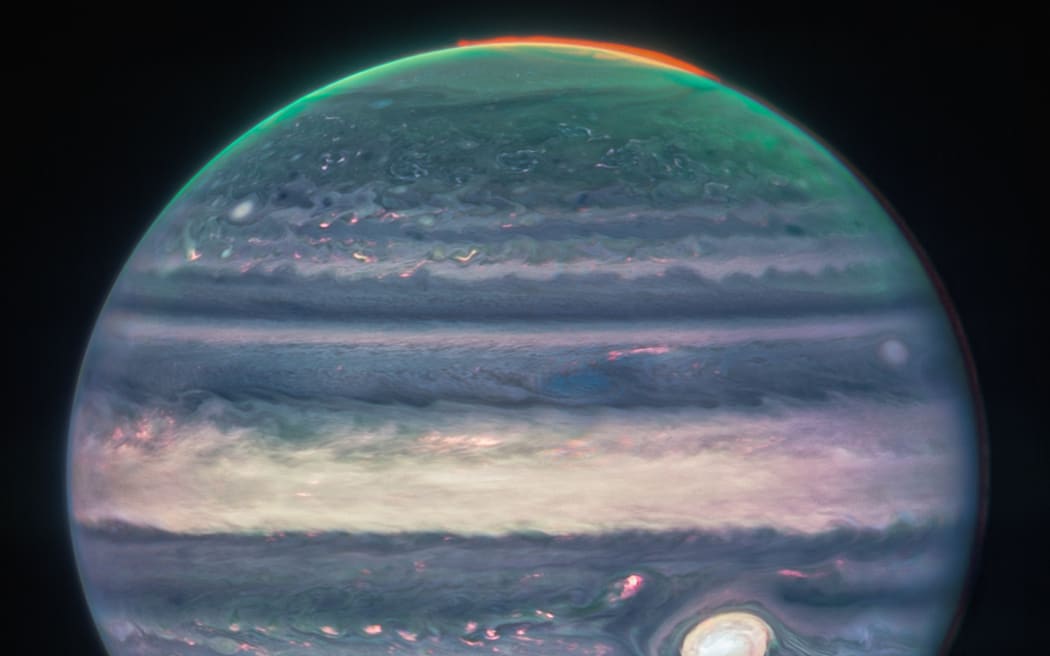 In this image obtained from NASA and taken by the James Webb Space Telescope, shows Jupiter's weather patterns, tiny moons, altitude levels, cloud covers and auroras at the northern and southern poles. (Photo by Handout / NASA / AFP) / RESTRICTED TO EDITORIAL USE - MANDATORY CREDIT "AFP PHOTO / NASA, ESA, CSA, Jupiter ERS Team; image processing by Judy Schmidt" - NO MARKETING NO ADVERTISING CAMPAIGNS - DISTRIBUTED AS A SERVICE TO CLIENTS