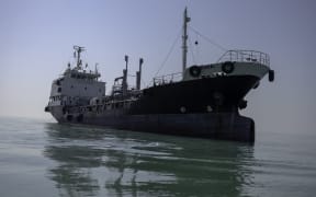 A large commercial ship floats off the coast in Bushehr, Iran, on January 15, 2025. Bushehr is Iran’s first nuclear seaport. (Photo by AMIR / Middle East Images via AFP)
